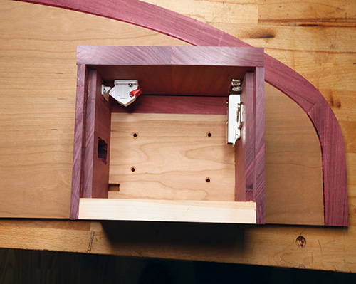 Holes cut in cubby body for installing electronics