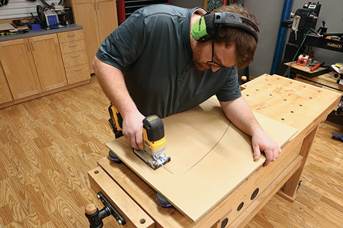 Using jigsaw to cut outline of shelf template