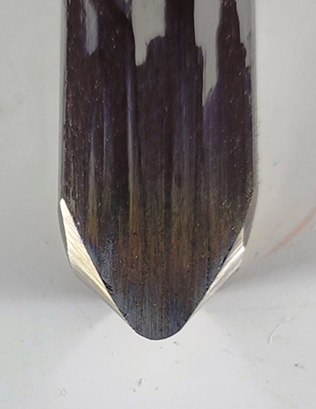 Top view of a woodturning gouge with a rolled-over wing