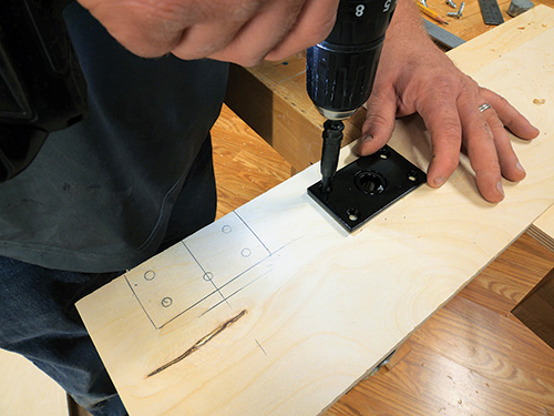 Screwing plate in place on Murphy bed