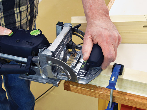 Cutting joinery on wood clamped to workbench
