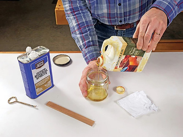 Pouring Tung oil to soak a tack cloth