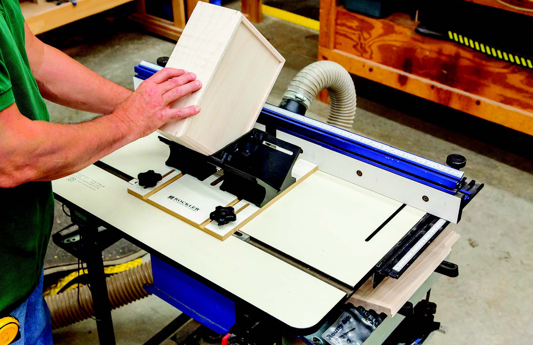 Rockler's new Router Table Spline Jig (left) and a 1/8-dia. straight bit make it easy to cut spline slots across the corners of this case.