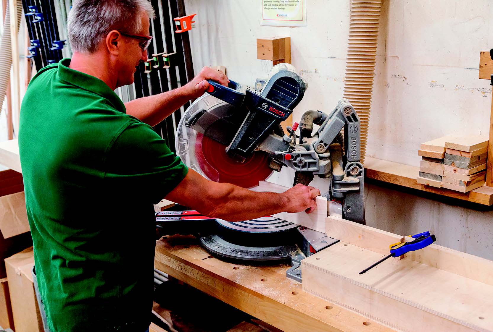 Miter-cut the case parts to 45° and to final length. Notice the stop block, clamped in place to the right of the saw, here. It ensures that you’ll produce matching parts of exact length when needed.