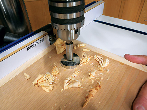 Boring holes for door pulls in sewing cabinet door panel