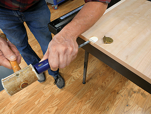 Chiseling out waste from hinge space on sewing cabinet door
