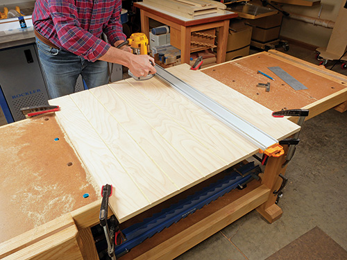 Using straight edge guide to cut cabinet panels