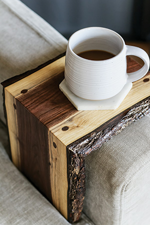 Armrest table laid out on sofa arm