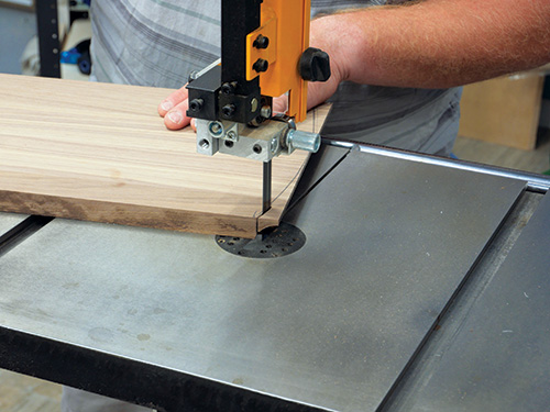 Trimming waste from door top with band saw