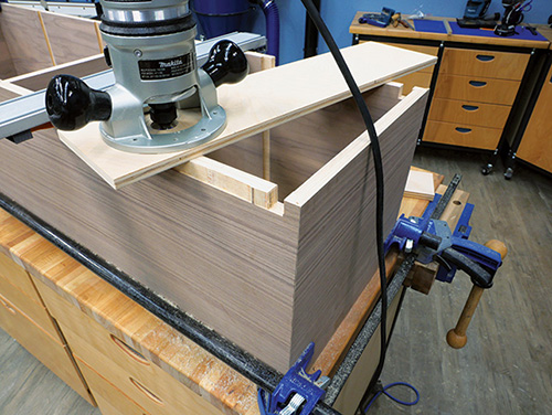 Shop-made jig for routing door recess in cabinet