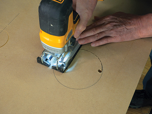 Using jigsaw to cut dust hose installation hole