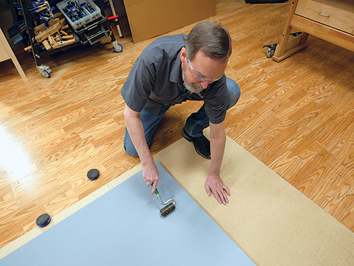 Securing laminate glue-up with roller