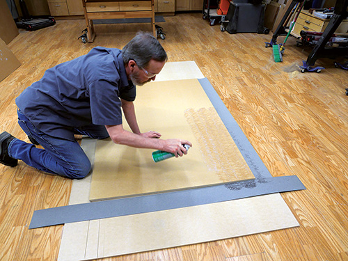 Spraying adhesive on MDF panel