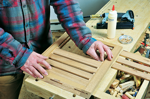 Spacer blocks set into the top and bottom frame rabbets keep the slat spacing even, and also fill the gaps in the frame.