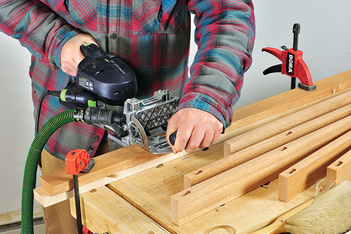 The author uses the Festool Domino system loose tenons to join the frame members of the ottoman.
