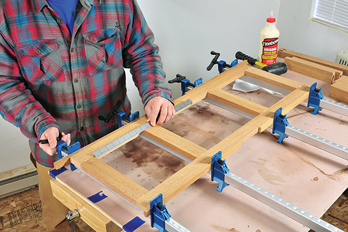 Use a ruler to make sure that the spaces for open panels on the long sides of the ottoman are even.