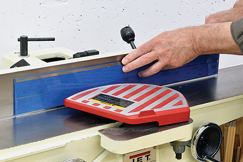 Smoothing edges of acrylic piece with jointer